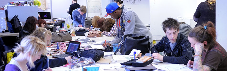students sat at a long desk working